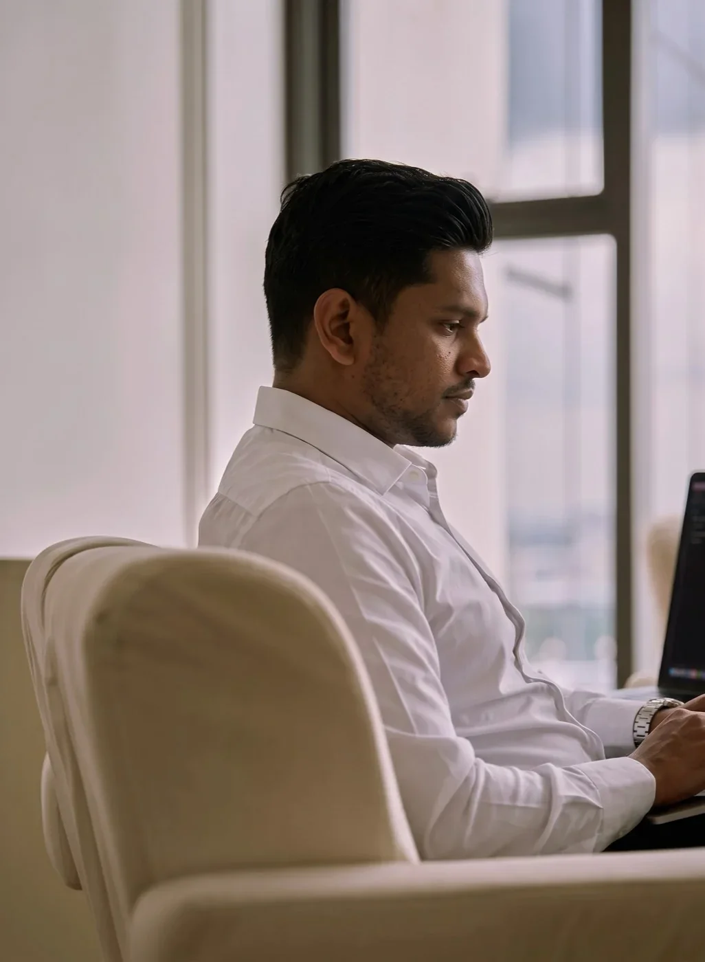 Working at a laptop beside a bright window
